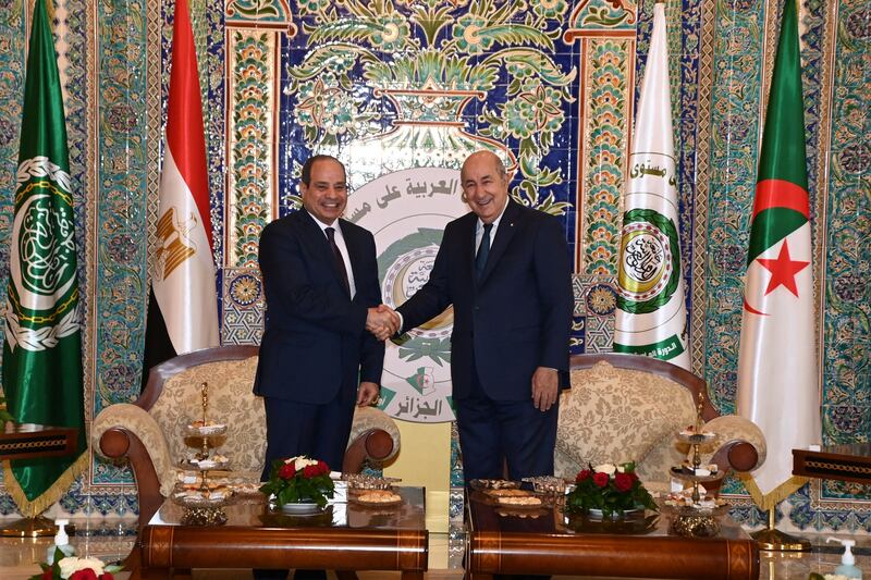 Mr El Sisi shakes hands with Mr Tebboune before the start of the summit in Algiers. Reuters