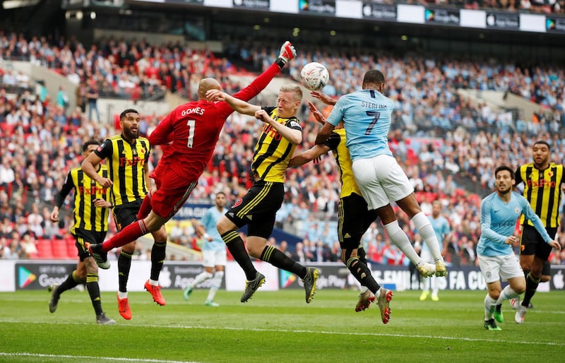 Manchester City's Raheem Sterling in action with Watford's Heurelho Gomes and Will Hughes. Reuters