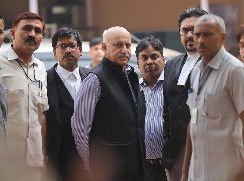 epa07132426 Former Junior Indian Minister for External affairs  MJ Akbar(C) along with the lawyers and Security personnel outside Patiala House court in New Delhi, India, 31 October 2018. According to news reports, MJ Akbar recorded his statements in the court after several women had accused him of sexual misconduct.  EPA/RAJAT GUPTA