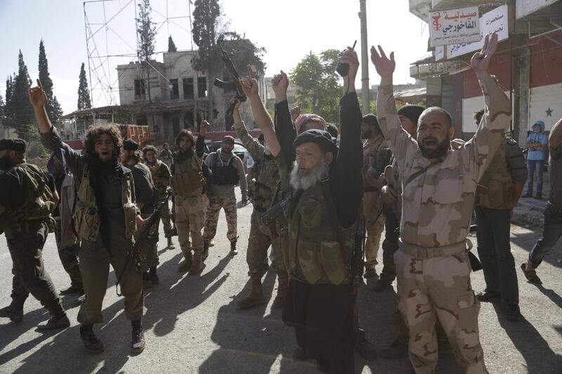 FILE PHOTO: Members of al Qaeda's Nusra Front gesture as they cheer in the northwestern city of Ariha, after a coalition of insurgent groups seized the area in Idlib province May 29, 2015. REUTERS/Khalil Ashawi/File Photo