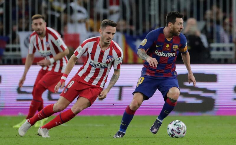 Barcelona's Lionel Messi, right, shields the ball from Atletico players. AP