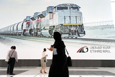 Delegates look at an Etihad Rail poster. The national rail network will connect Fujairah and Khorfakkan on the UAE’s east coast to the UAE’s border with Saudi Arabia at Ghuweifat. Pawan Singh / The National