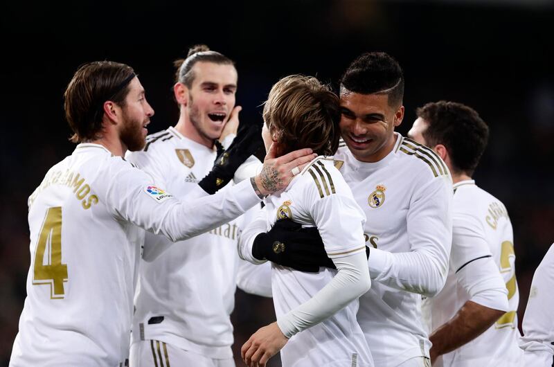 Luka Modri celebrates scoring his side's third goal with Gareth Bale. AP