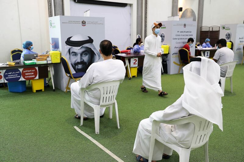 People waiting for their turn to get the Covid-19 vaccine at the Ajman Society of Social and Cultural Development. All photos: Pawan Singh / The National