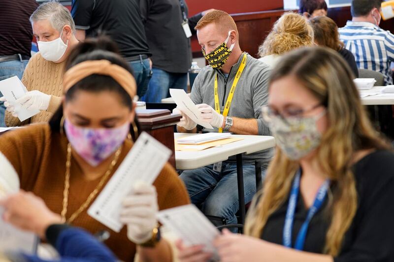 Municipal workers extract Luzerne County ballots from their envelopes, in Wilkes-Barre, Pa. The fate of the United States presidency hung in the balance Wednesday morning, as President Donald Trump and Democratic challenger Joe Biden battled for three familiar battleground states, Wisconsin, Michigan and Pennsylvania, that could prove crucial in determining who wins the White House. AP Photo