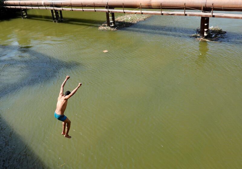 A boy jumps from a bridge into the Nile River to cool off from the hot and humid weather in Cairo, Egypt. Reuters