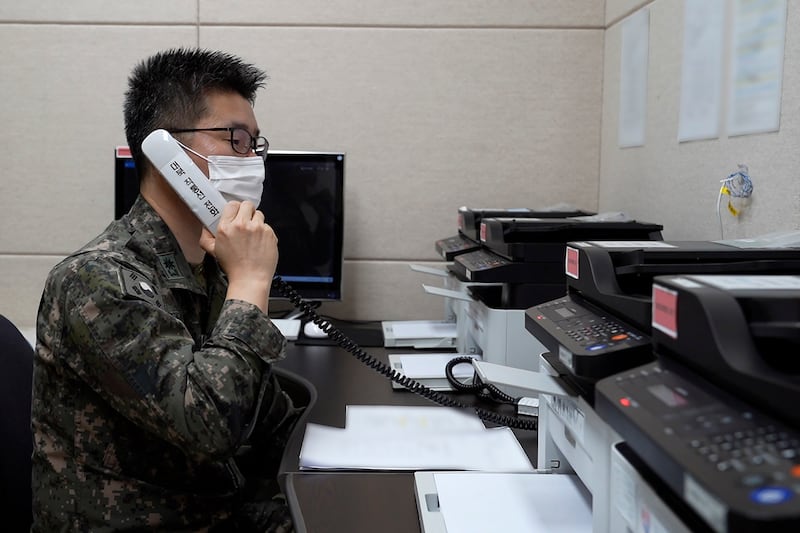 A South Korean military officer makes a test call with a North Korean officer through an inter-Koran military communication line at an undisclosed location near the demilitarised zone on Monday. Photo: AP