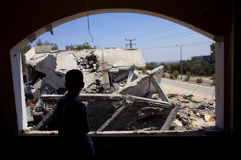 Ramez Hassouna, 40, looks out the window of his home in Beit Hanoun, built two years ago for his son and two daughters, at the devastation caused by an Israeli F-16 airstrike. Heidi Levine for The National