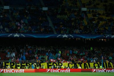 Supporters display a banner in support of Catalonia independence during the group D Champions League soccer match between FC Barcelona and Olympiakos at the Camp Nou stadium in Barcelona, Spain, Wednesday, Oct. 18, 2017. (AP Photo/Manu Fernandez)