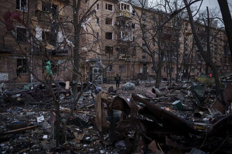 A police officer at abandoned residential buildings in Kyiv. AP