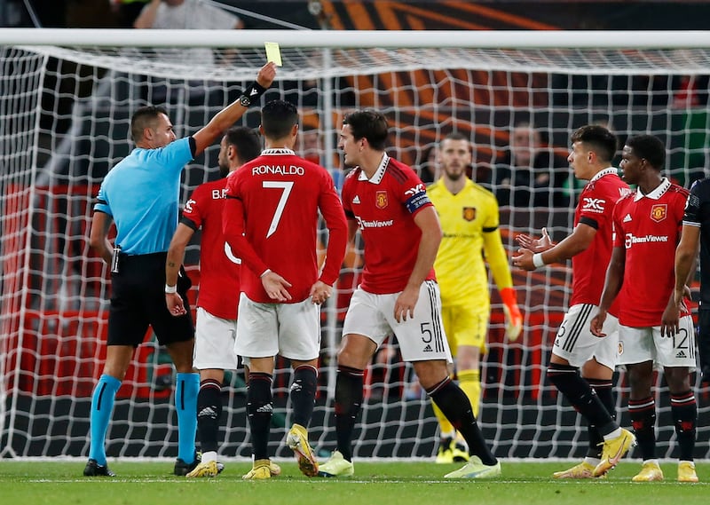 United's Lisandro Martinez is shown a yellow card by referee Marco Di Bello after he concedes a penalty. Reuters