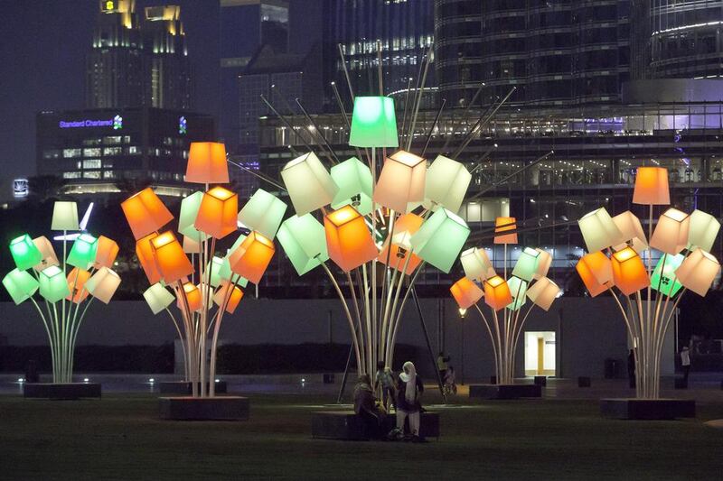 Families enjoy the Festival of Lights at the Burj Park in Downtown Dubai. More than 30 artists will take part to display well-known buildings and landmarks around the city during the inaugural event. Jaime Puebla / The National