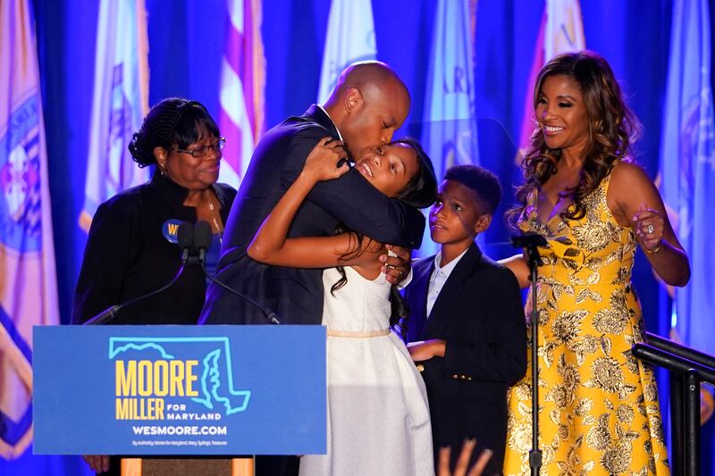 Democrat Wes Moore, second from left, hugs his daughter, Mia, centre, as his mother, Joy Thomas Moore, left, son, Jamie, second from right, and wife, Dawn, look on, after he  was declared the winner of the Maryland race for governor. AP