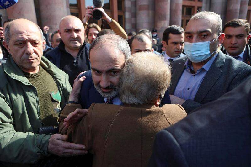 Armenian Prime Minister Nikol Pashinyan embraces a supporter after he called on followers to rally in the centre of Yerevan, Armenia. Pashinyan warned of an attempted military coup against him after the army demanded he and his government resign. Reuters