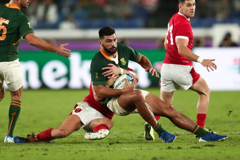 South Africa's centre Damian De Allende is tackled by Wales' fly-half Dan Biggar (2nd L) during the Japan 2019 Rugby World Cup semi-final match between Wales and South Africa at the International Stadium Yokohama in Yokohama.  AFP