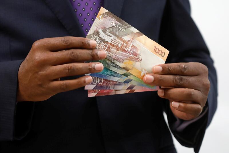 Kenya Central Bank Governor Patrick Njoroge displays the newly designed Kenyan shilling bank notes during a news conference at the Central Bank in Nairobi, Kenya, June 3, 2019. REUTERS/Baz Ratner