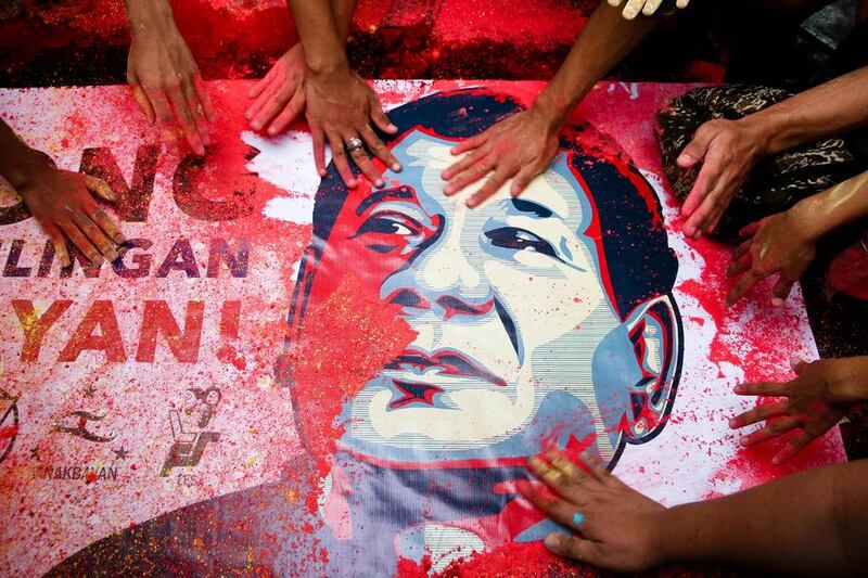 Duterte supporters touch a portrait of him during a rally in Manila.  J Gerard Seguia / Pacific Press / LightRocket via Getty Images