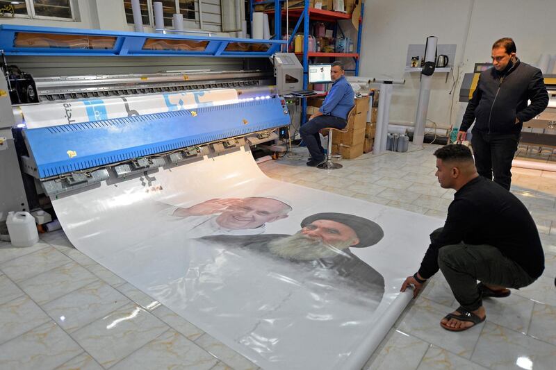 Iraqi men print a banner of Pope Francis and Shiite cleric Grand Ayatollah Ali Sistani at a factory in Najaf, before the first papal visit to Iraq. AFP