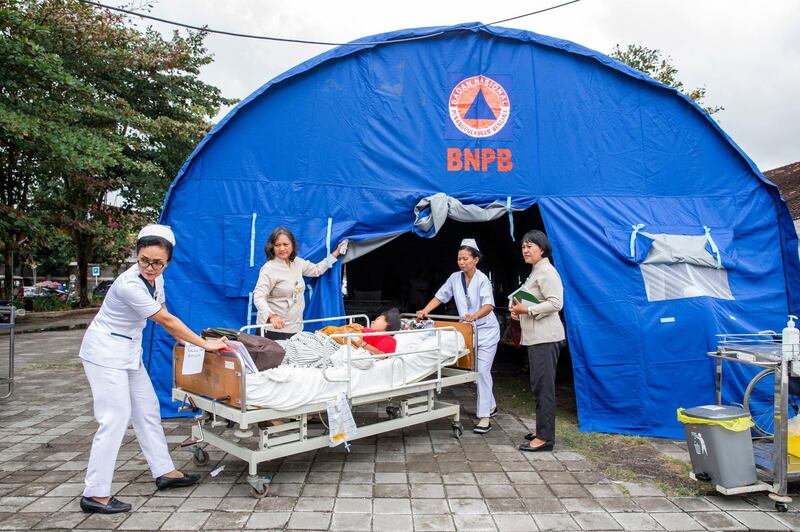 Hospital patients are moved to an emergency tent outside of a hospital building after an earthquake was felt in Denpasar, Bali. EPA