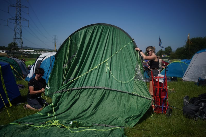 Campers put up their tent on the first day of the Glastonbury festival. Reuters