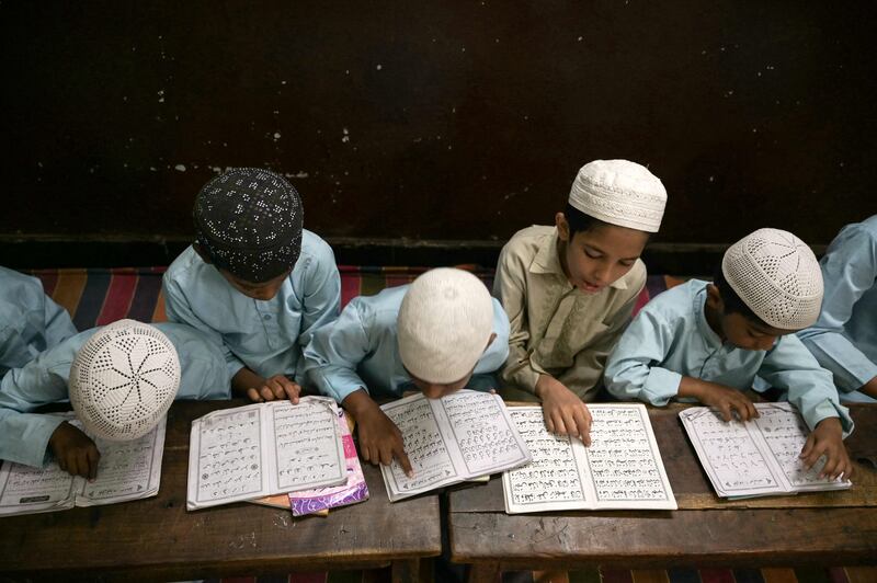 Pupils recite from the Quran at the Madrasatur-Rashaad religious school in Hyderabad, India. AFP