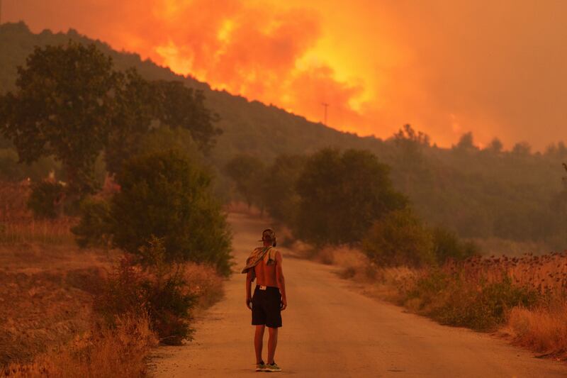 A wildfire approaches a village near Alexandroupolis in Greece earlier this year. Average global temperatures are on the rise. Bloomberg