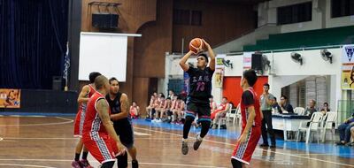 John Gil Aposaga takes a shot during an amateur basketball game. Photo: Alan Su