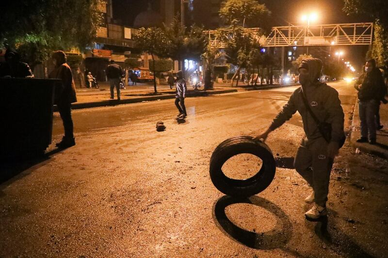 A demonstrator holds a tire during a protest against the lockdown and worsening economic conditions, amid the spread of the coronavirus disease (COVID-19), in Tripoli, Lebanon. Reuters
