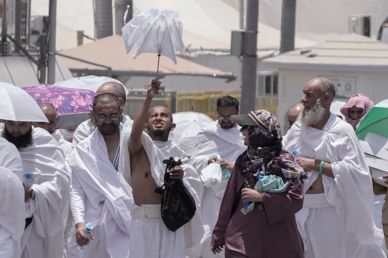 A pilgrim opens his umbrella at the Mina tent camp in Makkah, Saudi Arabia. AP