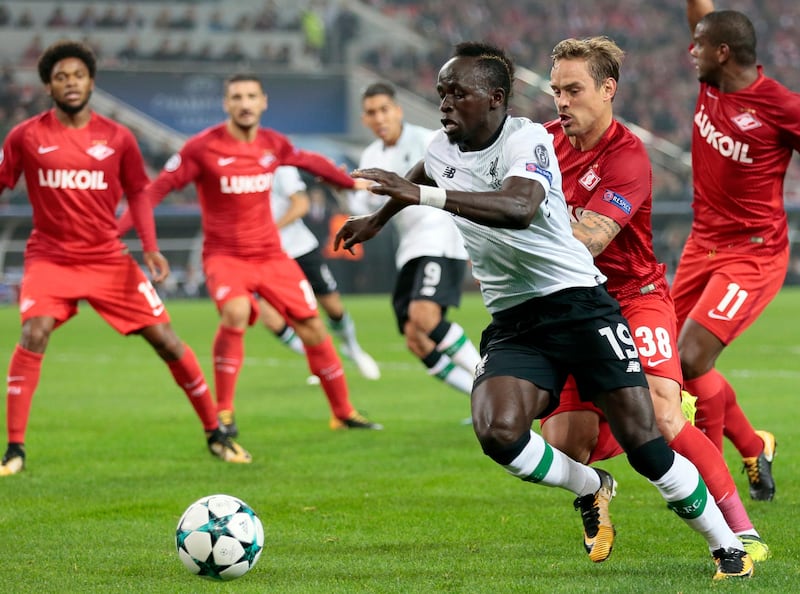 FILE - In this Tuesday, Sept. 26, 2017 file photo, Liverpool's Sadio Mane, front, duels for the ball with Spartak's Andrei Eschenko during the Champions League soccer match between Spartak Moscow and Liverpool in Moscow, Russia. Liverpool says Sadio Mane could be out for six weeks after sustaining a hamstring injury on international duty with Senegal on Saturday Oct. 7, 2017. (AP Photo/Ivan Sekretarev, File)