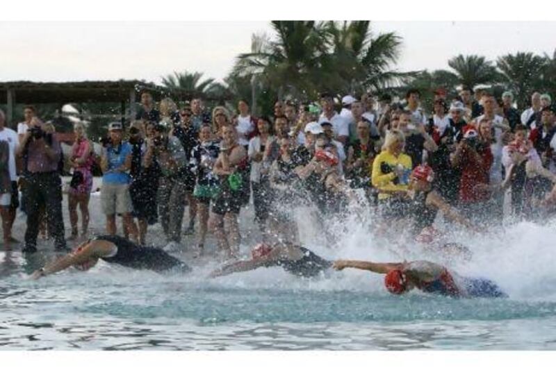 Women make a splash at the start of their race on the Corniche yesterday. Mike Young / The National