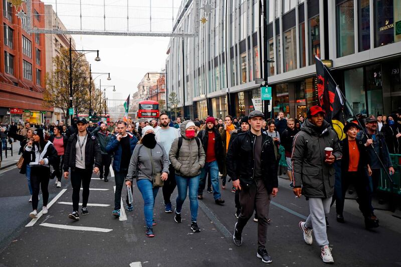 Protesters march through central London as they take part in an anti-lockdown protest against government restrictions designed to control or mitigate the spread of the novel coronavirus.  AFP