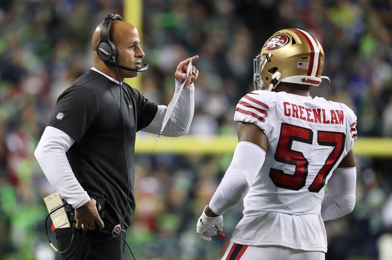 SEATTLE, WASHINGTON - DECEMBER 29: San Francisco 49ers Defensive Coordinator Robert Saleh has a conversation with Dre Greenlaw #57 of the San Francisco 49ers in the fourth quarter against the Seattle Seahawks during their game at CenturyLink Field on December 29, 2019 in Seattle, Washington.   Abbie Parr/Getty Images/AFP (Photo by Abbie Parr / GETTY IMAGES NORTH AMERICA / Getty Images via AFP)