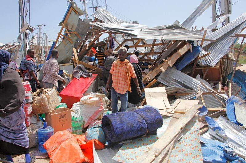 Somalis salvage goods after shops were destroyed in a car bomb in Mogadishu. AP Photo