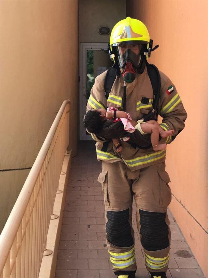 A baby is rescued from a burning third floor apartment in Discovery Gardens. Courtesy Dubai Civil Defence