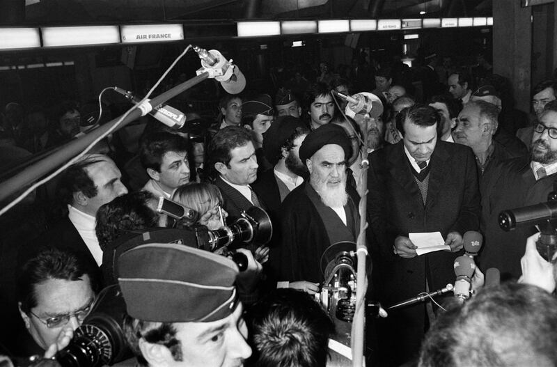 Iranian opposition leader in exile ayatollah Ruhollah Khomeiny gives a speech as journalists surround him at Roissy airport near Paris on January 31, 1979 before boarding an Air France "Jumbo Jet" bound to Tehran. Although Iran's US-backed shah had already fled the country when Khomeini returned from exile in the small French town of Neauphle-le-Chateau, the 747's landing is seen as the true start of the Islamic revolution. AFP PHOTO MARCEL BINH (Photo by MARCEL BINH / AFP)