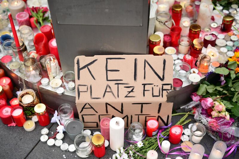 A sign reading 'no place for anti-semitism' is placed at a makeshift memorial in Halle on October 10, 2019. EPA