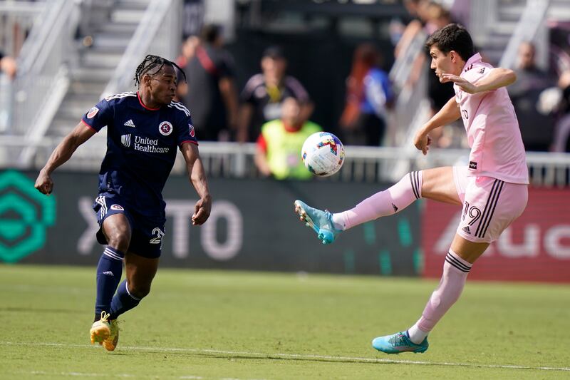 Inter Miami forward Robbie Robinson passes the ball as New England Revolution forward DeJuan Jones defends during a football match in April. AP