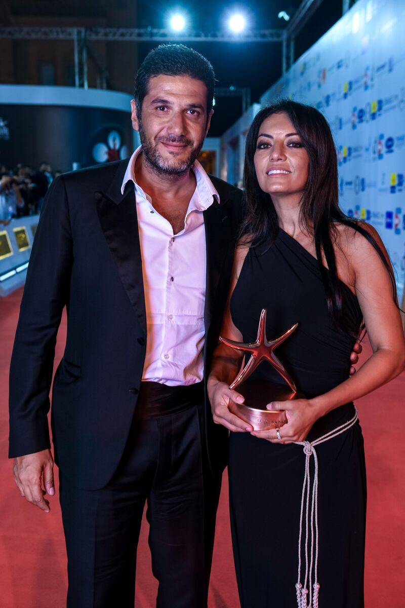 Nabil Ayouch and Maryam Touzani pose with their Bronze Star award for the movie 'Adam' during the closing ceremony of El Gouna Film Festival. AFP