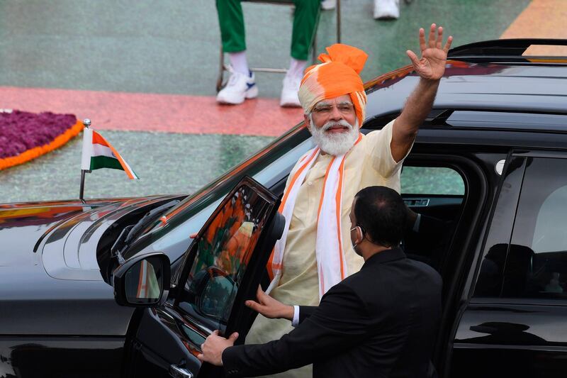 Indian Prime Minister Narendra Modi waves as he leaves in a car after his speech to the nation. AFP