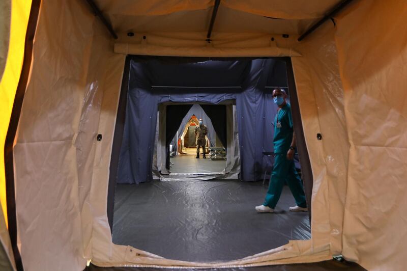 Italian medics walk around in the Italian field hospital in the Lebanese University campus in the town of Hadath, north of the capital Beirut. AFP