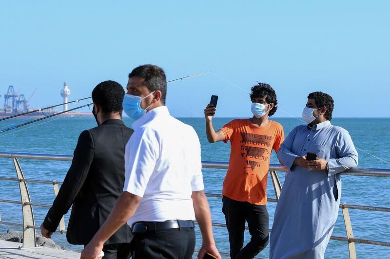 People spend time at the seafront promenade in the Saudi port city of Jeddah as the country reopens following the lifting of a lockdown due to the Covid-19 pandemic. AFP