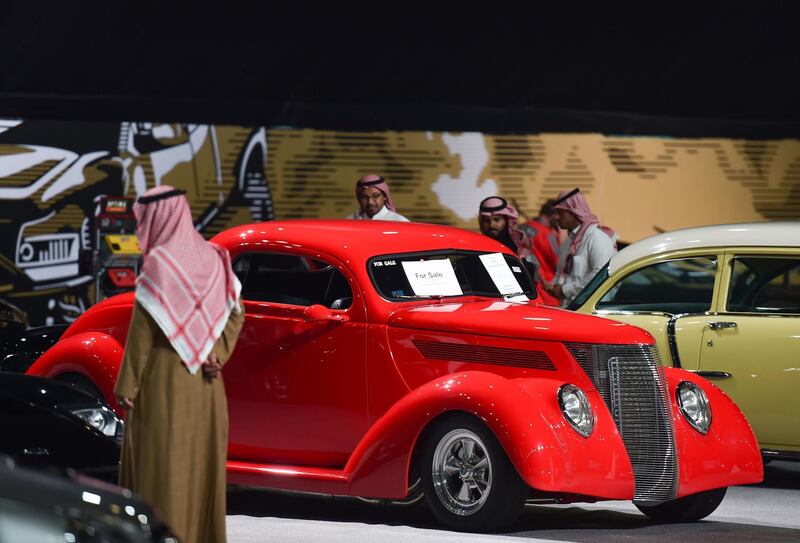 Visitors view classic cars displayed for sale in a special exhibition, during the Riyadh Motor Show at Al-Janadriyah village in the Saudi capital. AFP