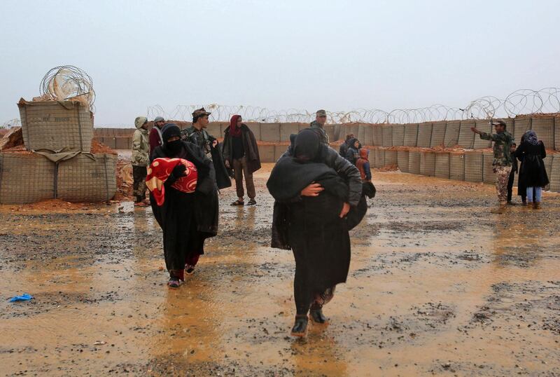 (FILES) In this file photo taken on March 1, 2017, Syrian refugee patients from the makeshift Rukban camp, which lies in no-man's-land off the border between Syria and Jordan in the remote northeast, cross over to visit a UN-operated medical clinic immediately on the Jordanian-side for checkups. In a desert camp along Syria's border with Jordan, nearly 50,000 displaced people struggle to eke out a living. There are no clinics, no nappies and little food -- welcome to Rukban. / AFP / KHALIL MAZRAAWI
