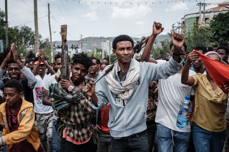 Soldiers of Tigray Defence Force (TDF) react to people as they are welcomed on a street in Mekelle.