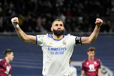 Real Madrid's French forward Karim Benzema celebrates after scoring a goal during the Spanish league football match between Real Madrid CF and Real Sociedad at the Santiago Bernabeu stadium in Madrid on March 5, 2022.  (Photo by PIERRE-PHILIPPE MARCOU  /  AFP)