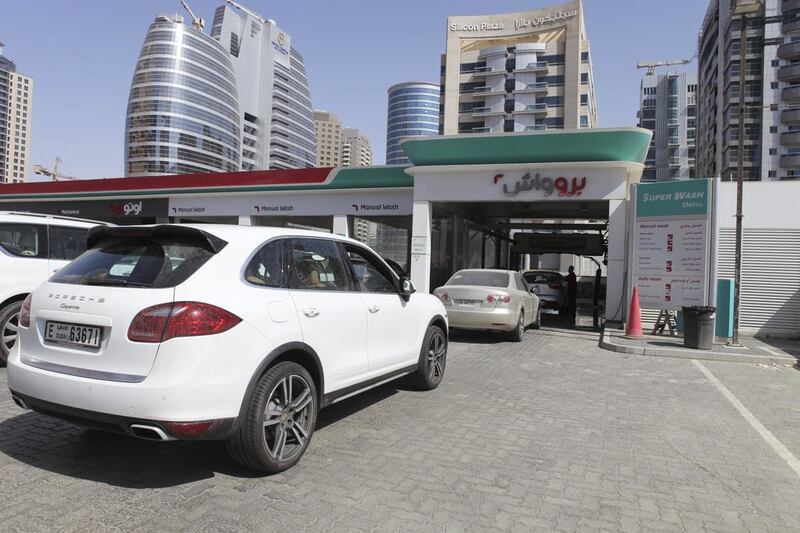 Motorists in Dubai queue up to wash their cars at the Enoc petrol station by the Greens. Razan Alzayani / The National