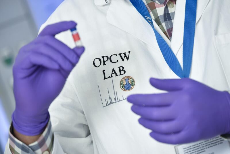 TOPSHOT - A laboratory technician controls a test vial at the OPCW (The Organisation for the Prohibition of Chemical Weapons) headquarters in the Hague, The Netherlands, on April 20, 2017. 
Tucked away in a small industrial zone in the Dutch suburb of Rijswijk, the two-storey building, with about 20 staff, has been key to the two decades of painstaking work by the Organisation for the Prohibition of Chemical Weapons (OPCW) to eliminate the world's toxic arms stockpiles. / AFP PHOTO / JOHN THYS