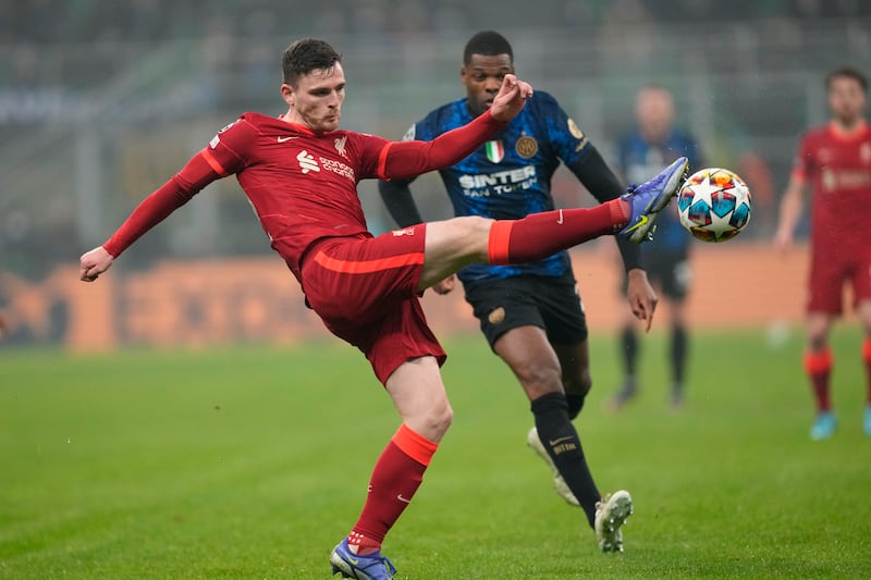 Liverpool's Andrew Robertson clears the ball from Inter's Denzel Dumfries. AP 