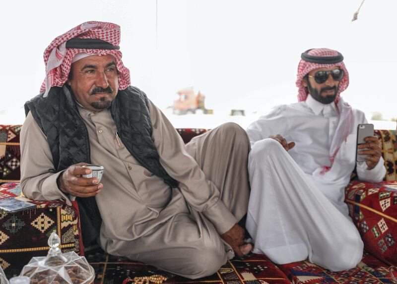 Abu Dhabi, United Arab Emirates, December 11,2019.  
  -- Mohammed Al Merri discusses camel pageant strategy at his family's tent in the dunes of Al Dhafra.
Victor Besa/The National
Section:  NA
Reporter:  Anna Zacharias